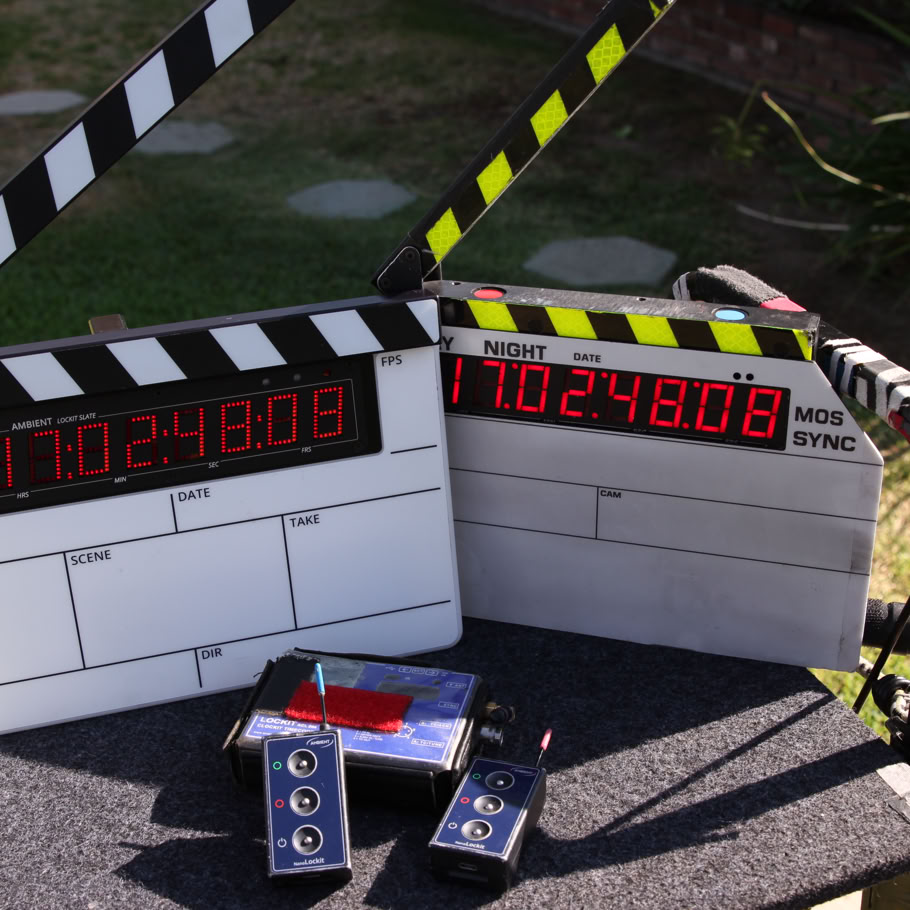 Cameraman using professional equipment to film in a dimly lit studio setting.