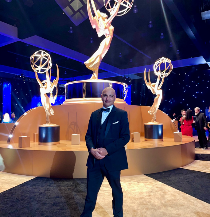A detailed view of a hand operating a professional audio mixer in a music studio.